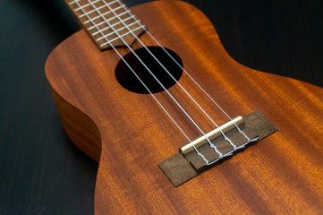 Instrument Hawaii ukelele made of wood with wood pattern on the table in the house