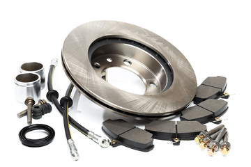 brake parts on white: brake pads, disc, brake hose, guides, cylinders .