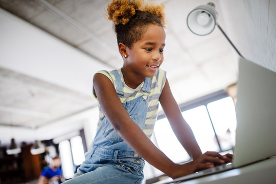 Game, study, fun concept. Happy children spending time with notebook and modern technology.