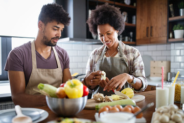 Happy couple preparing healthy food in kitchen