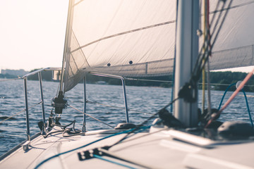 White cloth fabric, masts and ropes close-up on sail of tri-yacht or yacht sailing boat