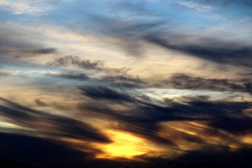Fototapeta na wymiar evocative sunset image with black clouds and blue sky