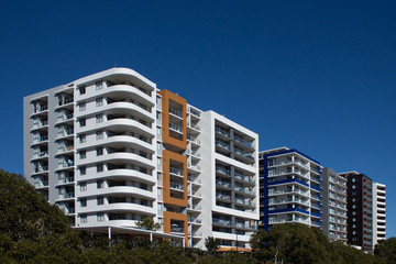 Urban high rise apartment condominiums community against blue sky