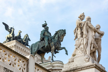 Fototapeta na wymiar The Victorian, sculptures of Piazza Venezia in Rome, with bronze statue of Victor Emmanuel II
