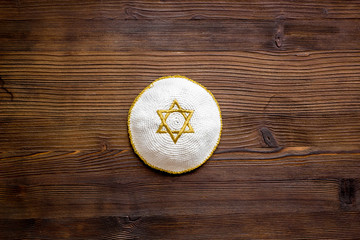 Jewish Kippah Yarmulkes hats with Star of David on wooden table. Religion Judaisim symbol. Top view, space for text