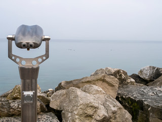 coin operated binoculars looking out in garda lake