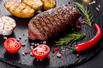 Ribeye steak with potatoes, onions and cherry tomatoes