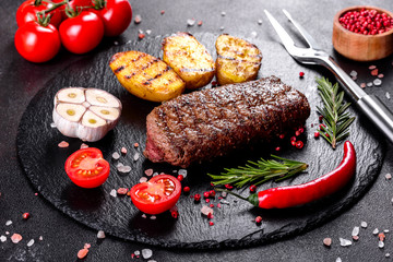 Ribeye steak with potatoes, onions and cherry tomatoes