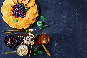 Obraz na płótnie Canvas oatmeal pancakes on a plate with berries