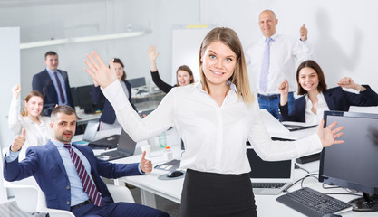 Woman with glad team celebrating victory