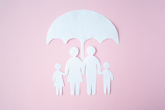 Concept of Social Protection Family. Paper cut Family Under Umbrella on bright pink background. Life insurance, family protection