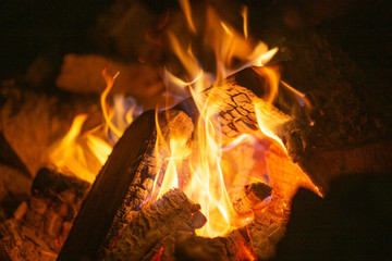 Closeup of a bonfire; fire burning firewood at night on a winter night during a campfire