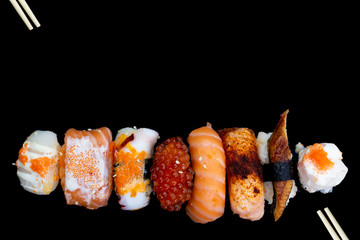 Sushi with chopsticks, Japanese sushi with soy sauce and wasabi.