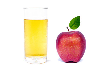 Glass of apple juice and red apple with green leaf