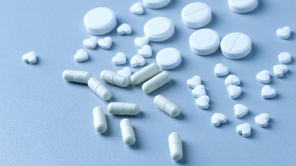 Closeup of many white tablets, pills and capsules