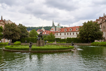 Fototapeta na wymiar Prague, Czech Republic - May 29, 2019: Hercules statue in the middle of a pond in the Waldstein garden, Prague, Czech Republic