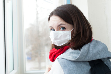 woman with mask in hospital looking on a window with text coronavirus . Concept of coronavirus quarantine. MERS-Cov. Novel coronavirus (2019-nCoV)