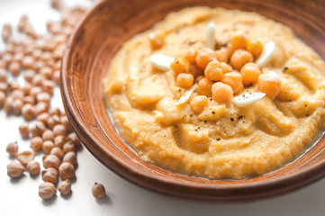 homemade hummus in a clay bowl. top view