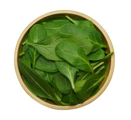 Fresh baby spinach leaves in wooden bowl isolated on white background with clipping path. Top view