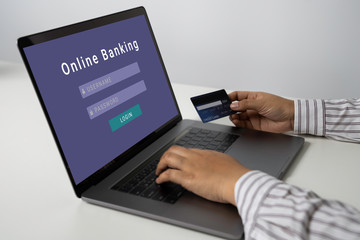 Person using online banking with credit card on touch screen device. Internet online banking. Digital and internet payments shopping on network. All on screen and credit card are designed up.