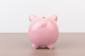 Piggy bank  on wooden background, space for text. Finance, saving money