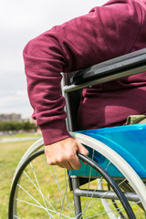 Man in wheelchair taking a walk in the park