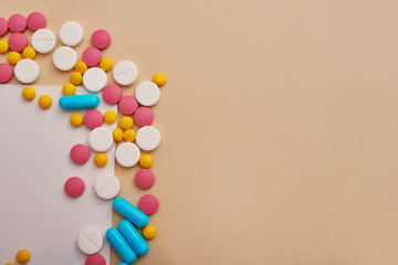 Assorted pharmaceutical medicine pills, tablets and capsules on beige background. Heap of various pills. Coronovirus, quarantine, epidemic, pandemic, flu, cold,illness. Medicine concept and health