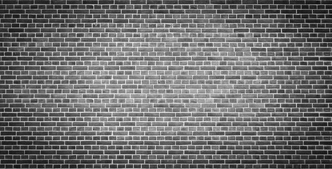 An old black bricks wall surface abstract pattern background. Background of old vintage brick wall with vignetting.