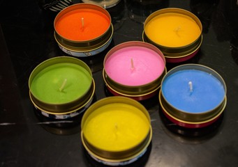 Closeup shot of colorful candles in tin cans