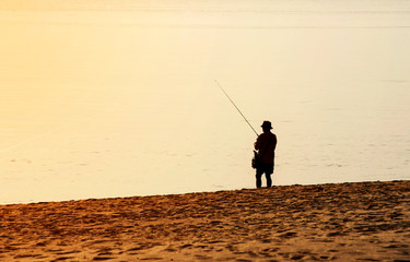 fishermen fishing the cooking food in the seaside dawn