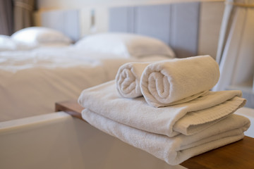 cleaning hotel, bath towel on white bed, room service 