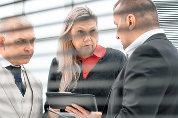 close up. a group of business people standing in the lobby of a modern office.