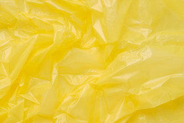 Close up Texture of a Yellow Plastic garbage Bag. Yellow Polyeth