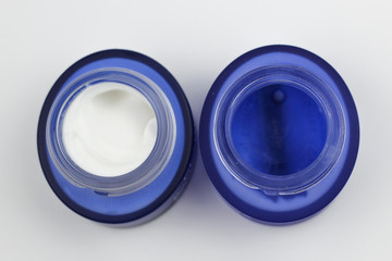 two full and empty face cream jars
