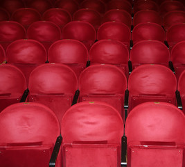 Classic rows of empty reddish seats in theatre