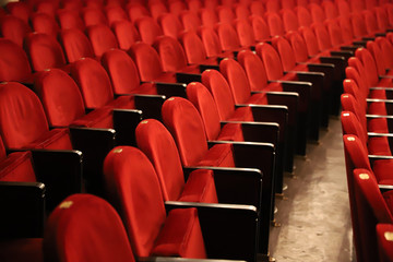 Classic rows of empty reddish seats in theatre