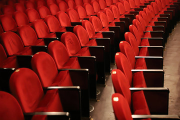 Classic rows of empty reddish seats in theatre