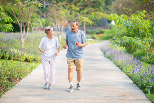 Asian senior retired couple jogging or exercise in the park. Healthy elderly people concept