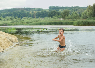 Little boy is playing in the water