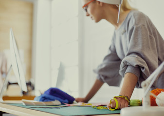 Obraz premium Fashion designer woman working on her designs in the studio