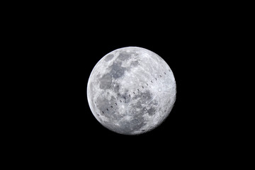 Obraz na płótnie Canvas The international space station (ISS) transits the full Moon, Chiang Mai, Thailand.