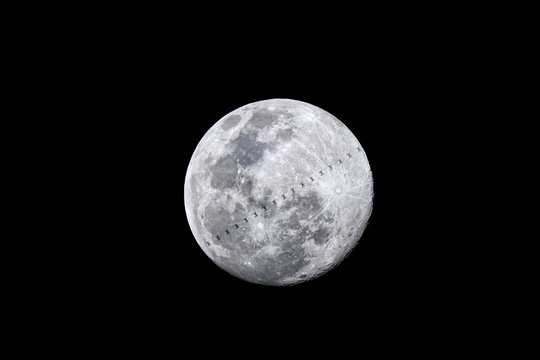 The international space station (ISS) transits the full Moon, Chiang Mai, Thailand.
