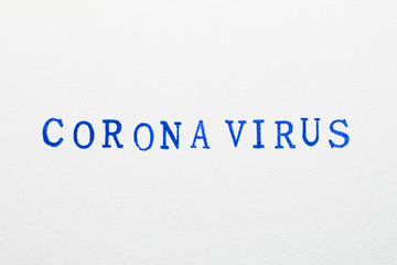 Fototapeta na wymiar a corona virus word stamped on a piece of paper.