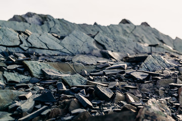 The top of a rocky mountain range. Gray flat stones. Rocky rock