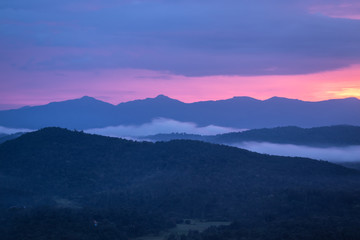 Misty mountains range with amazing sky