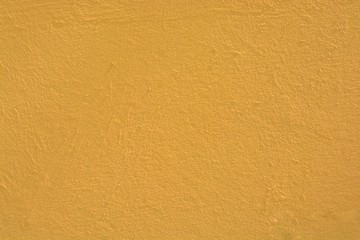 Wide shot of a concrete surface painted in a pale orange color