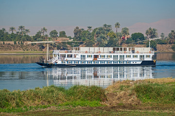 Fototapeta na wymiar Large egyptian river cruise dahabeya boat sailing on Nile