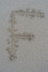 handwriting alphabet on the sand