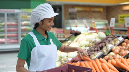 Shopping concepts. The girl is adding fruits and vegetables to shelves in the mall. 4k Resolution.