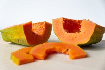 Sliced papaya on a white cutting board